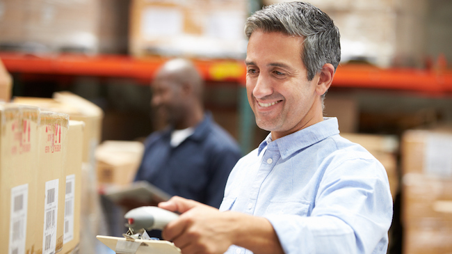 Man in Warehouse Scanning Boxes