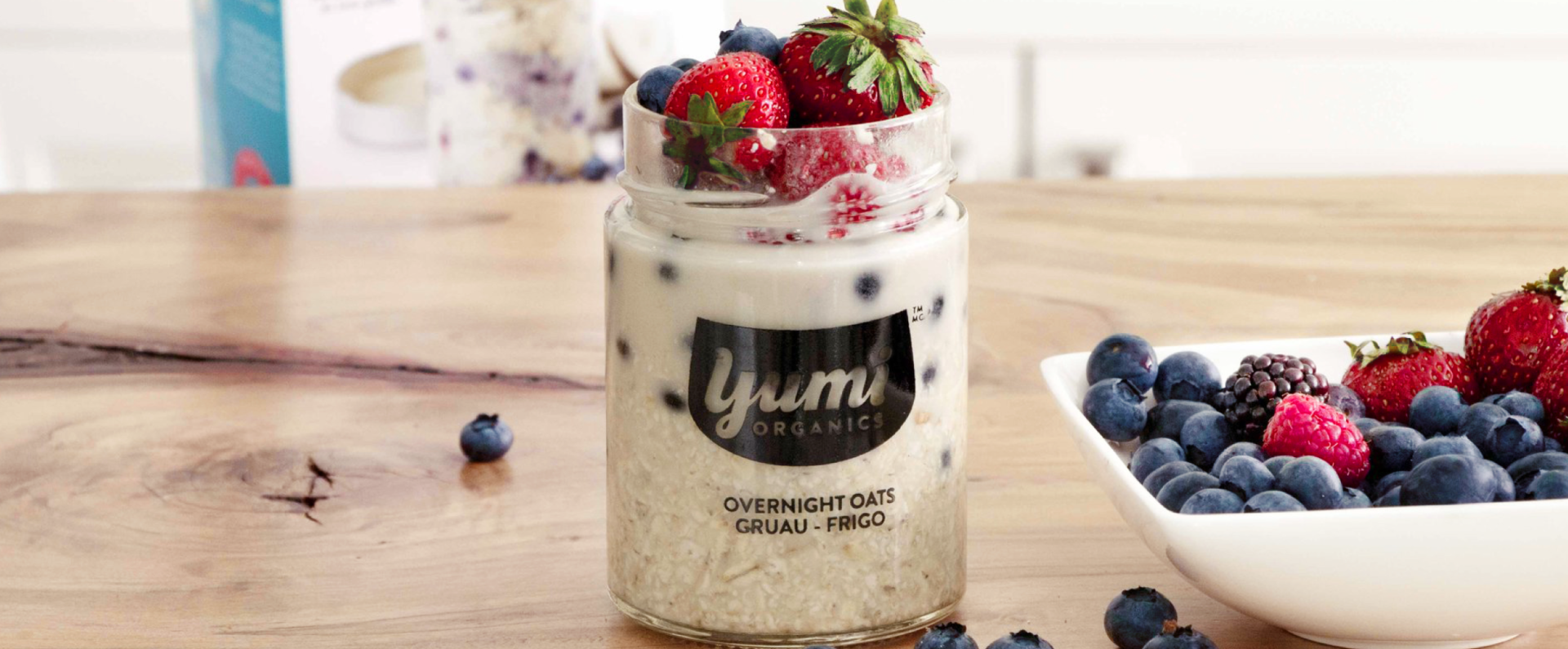 Photo of Yumi Organics overnight oats on a counter with fresh berries