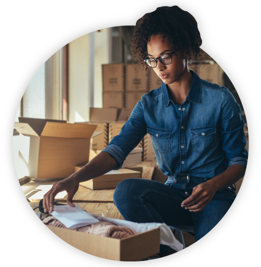Woman packing up an order into shipping box